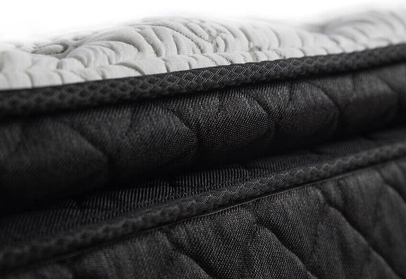 Image of the black diamond stitching and quilted white pillow-top of the Logan & Cove luxury hybrid mattress.