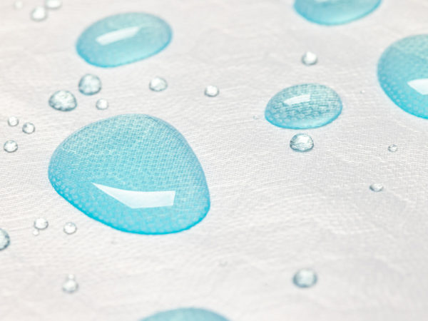 Gros plan de gouttes de liquide sur la surface du protège-oreiller